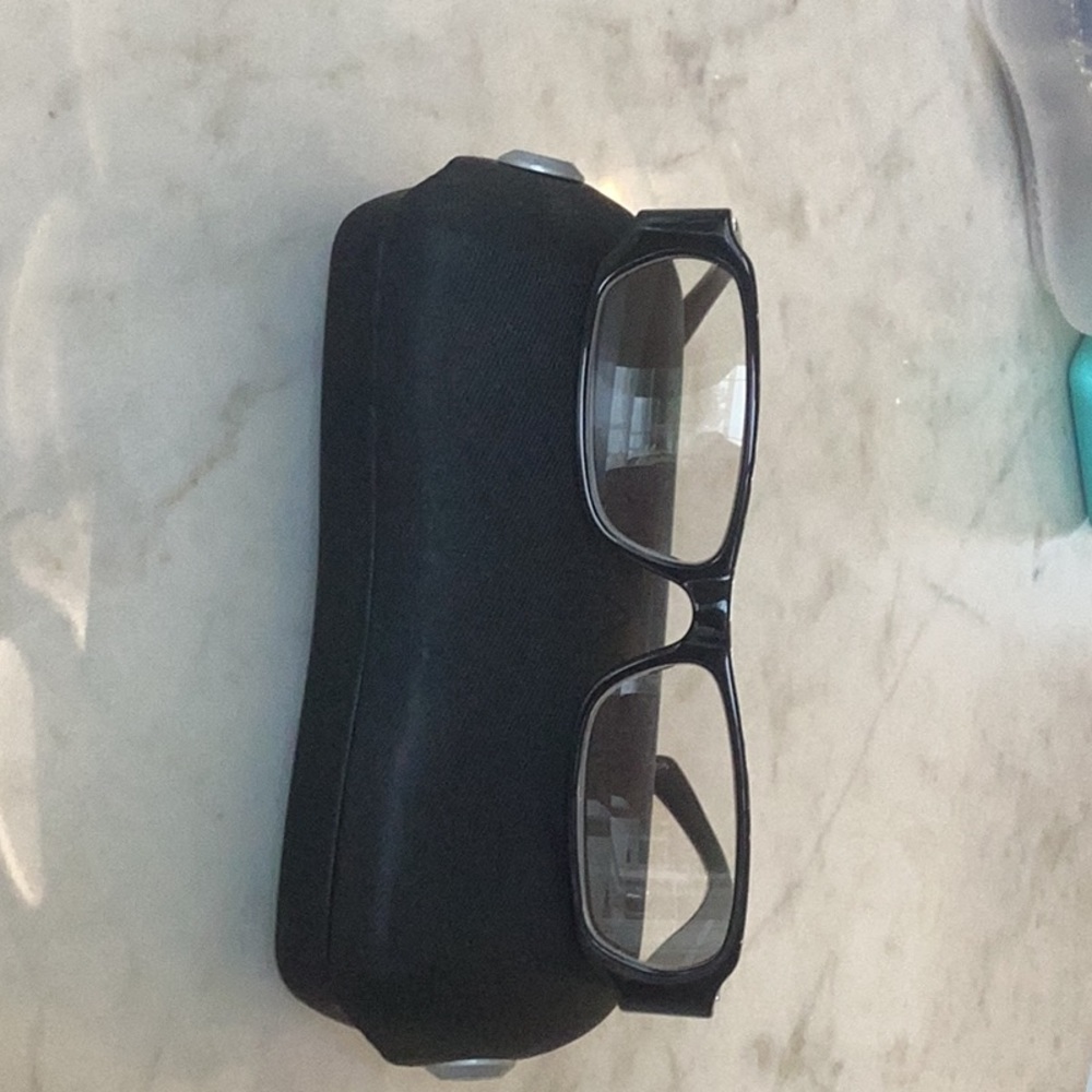 Chanel Paris reading glasses with black frames and pearl accents on arms.
